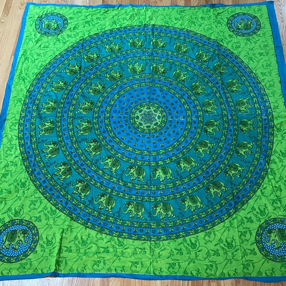 Blue and lime green tapestry with elephants.